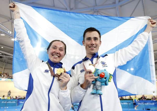 Katie and John Archibald celebrate winning their medals on the Gold Coast