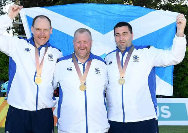 Ronnie Duncan, Darren Burnett and Derek Oliver, show off their medals after clinching the Triples title at the Broadbeach Club. Pic: Bradley Kanaris/Getty Images