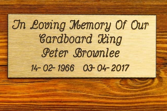 Pictured is the plaque on Peter's bench at the front of the store.