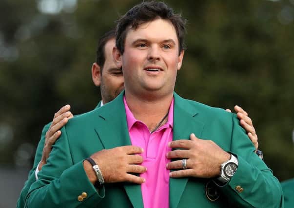 Patrick Reed  is given his Green Jacket by Sergio Garcia