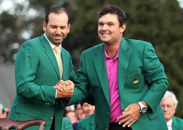 Patrick Reed (R) of the United States is congratulated by Sergio Garcia