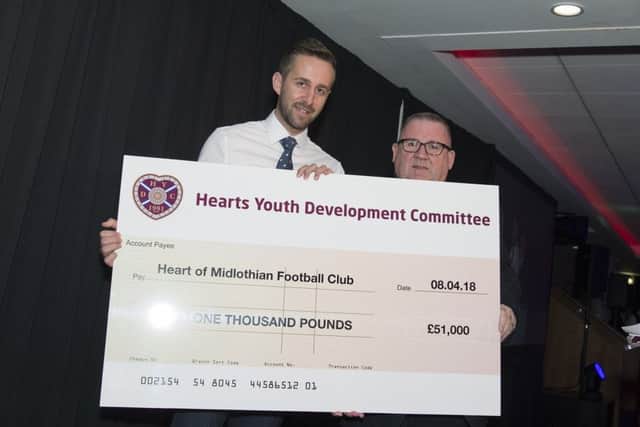 HYDC chairman Calum Robertson presents the last cheque to Hearts academy director Roger Arnott.