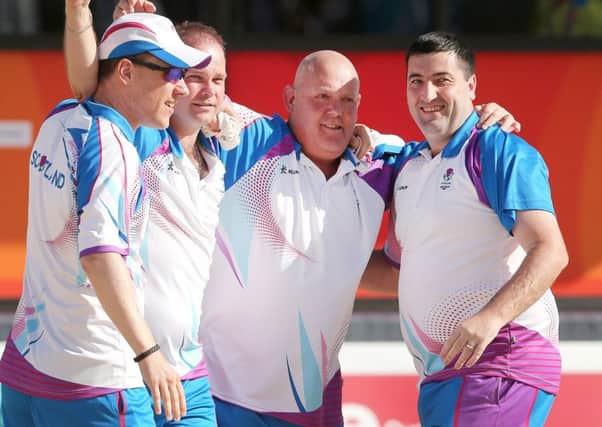 Ronnie Duncan, Paul Foster, Alex Marshall and Derek Oliver celebrate winning the gold medal match