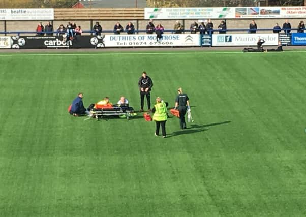 Ousman See of Berwick Rangers FC receives medical attention after breaking his leg.