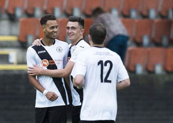 Then Edinburgh City player Ousman See (left) celebrates after he gets one back for his side against Hibs. Picture: SNS