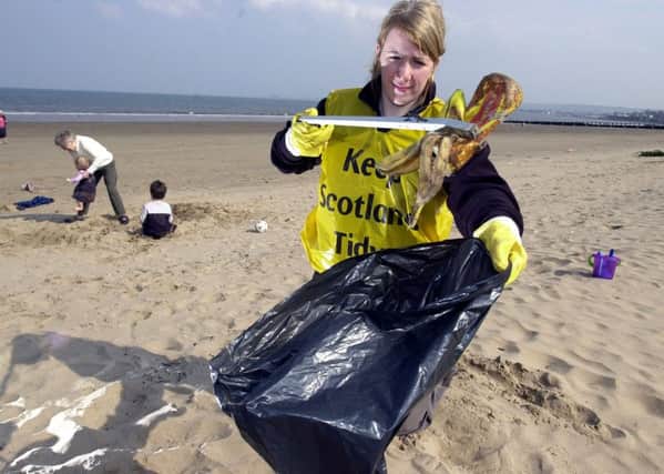 A volunteer helps clean up Portobello beach