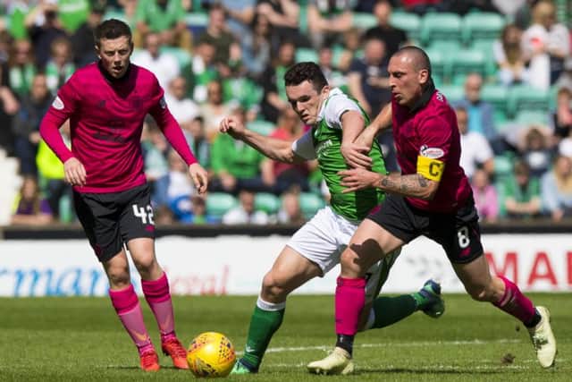Hibs midfielder John McGinn tussles with Celtic captain Scott Brown during the 2-1 win at Easter Road. Pic: SNS