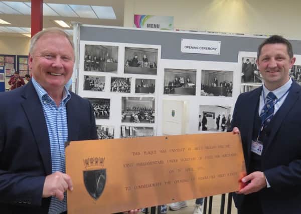 Newbattle High School exhibition - former head teacher Colin Taylor with the current head teacher, Gib McMillan. They are holding the official plaque to mark the unveiling of the school at the official opening in 1970 by Bruce Millan, the former Secretary of State for Scotland.