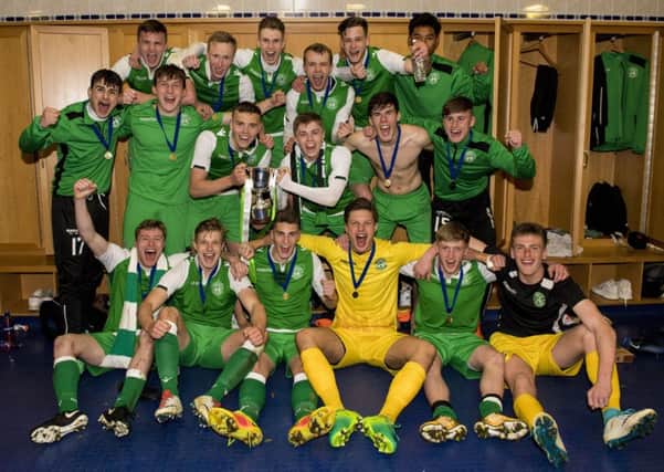 Hibs Under-20s show off a rather squint-looking Scottish Youth Cup after defeating Aberdeen at Hampden. Pic: SNS