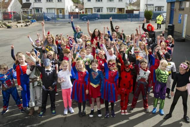 Gylemuir Primary School pupils and staff dressed up as Superheroes having a Superhero dance off in the playground at playtime.