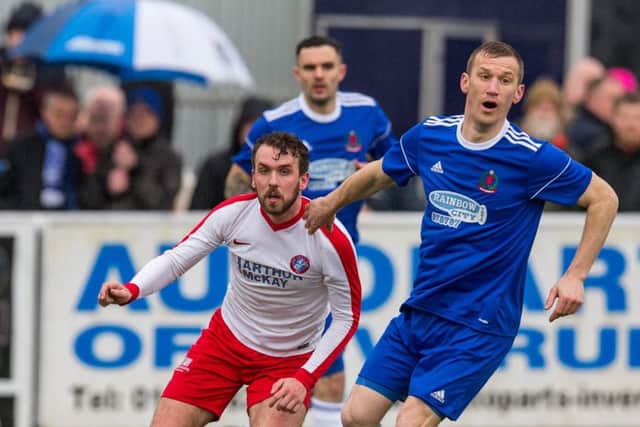 Spartans midfielder Ian McFarland tries to shake off the attentions of Coves Eric Watson at Harlaw Park. Pic: Brian Young