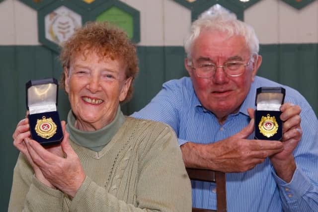 Joyce and Peter Jack with their medals.