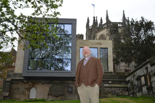 The cornerstone centre of St Johns church on Edinburghs princes street today with rector Rev Markus Dunzkofer