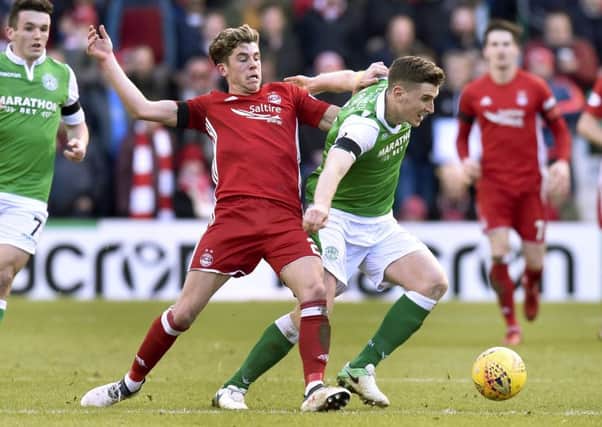 Paul Hanlon holds off Ryan Christie in the last meeting between the two teams. Picture: SNS Group