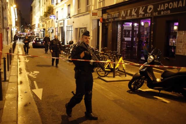 A police officer cordons off the area after a knife attack in central Paris. Picture: AP