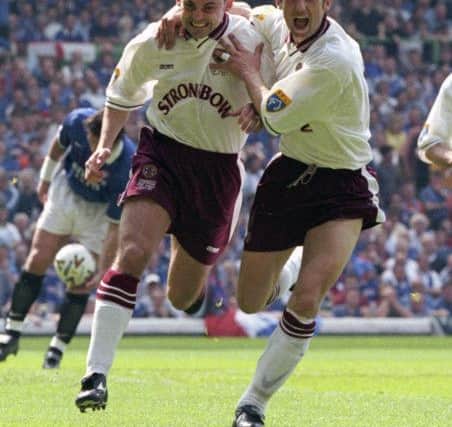 Colin Cameron (left) celebrates with Neil McCann after giving Hearts an early lead from the penalty spot
