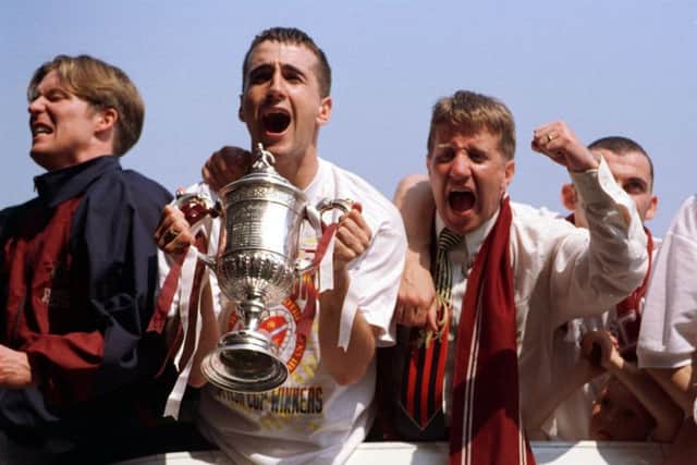 Gary Locke, Paul Ritchie and John Robertson celebrate on the open top bus