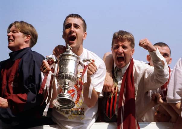 Gary Locke, Paul Ritchie and John Robertson celebrate on the open top bus