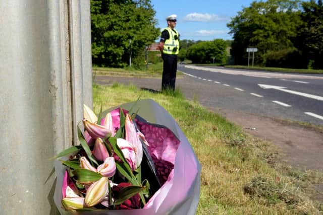 Locals have left bouquets of flowers at the scene. Picture: Lisa Ferguson