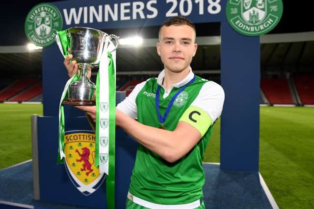 Porteous lifts the Scottish Youth Cup trophy. Pic: SNS