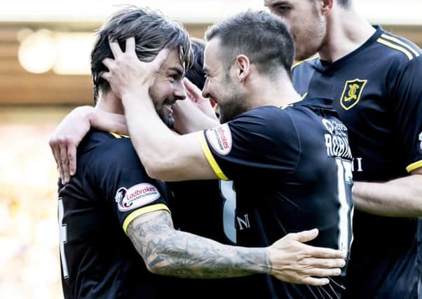 Scott Robinson congratulates Keaghan Jacobs after his equaliser for Livingston on Thursday night. Pic: SNS