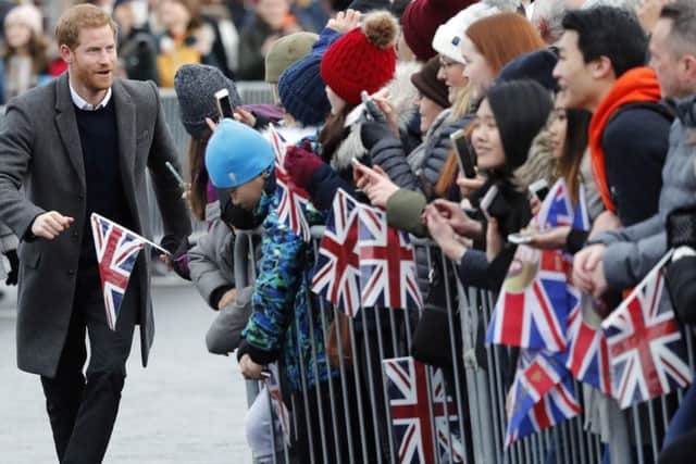 Prince Harry greets the public on a trip to Edinburgh Castle (Picture: AP)