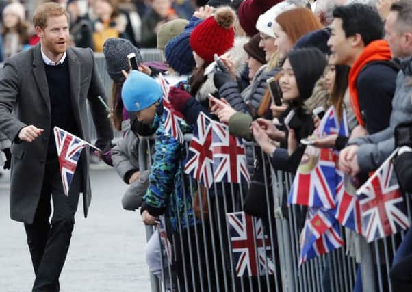 Prince Harry greets the public on a trip to Edinburgh Castle (Picture: AP)