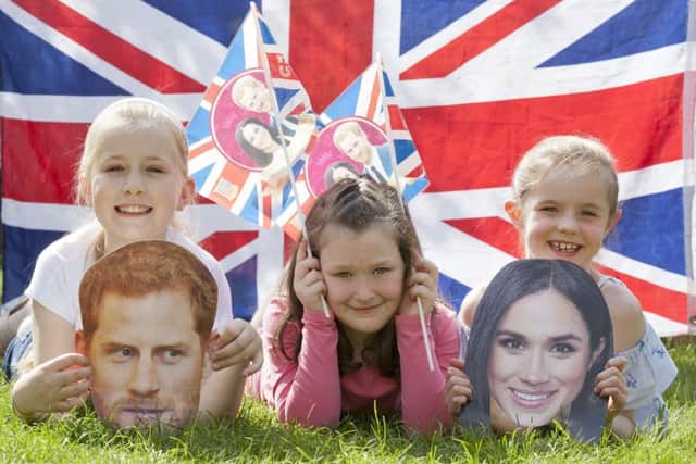 Getting ready for a royal wedding street party  - 
left Harry mask, Jessica Smith 9, middle Eilidh Gibson 8 and Belle Logan, 8 with Meghan mask