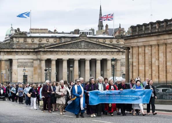 Female Ministers and supporters processed up The Mound in Edinburgh  to celebrate the 50th anniversary of the ordination of women into ministry in the Church of Scotland.
