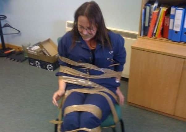 DeeAnn Fitzpatrick is pictured apparently gagged and strapped to a chair