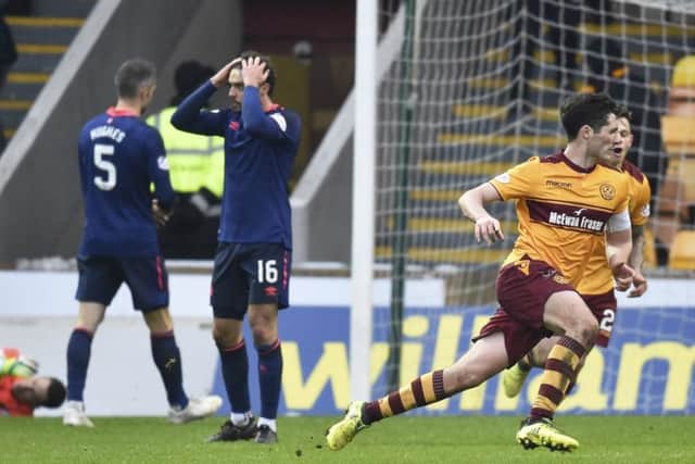 Carl McHugh rushes off to celebrate his late winner against Hearts in the Scottish Cup quarter-finals