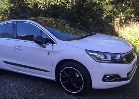 The car is described as being white with a black roof and alloy wheels and the registration number SK18 HZW