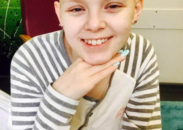 Kira Noble, 14, smiles, having had her tumour successfully in New York