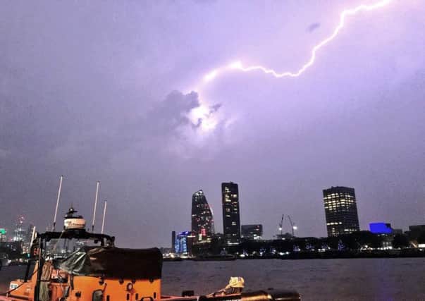This photo made available by RNLI, shows a lightning strike during a storm in London, Saturday May 27, 2018.  (Matt Leat/RNLI via AP)