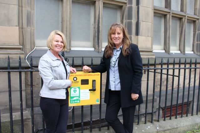 Defibrillator donor Diane Harvey with fundraising champion Lynn Cleal on MacDonald Road. Picture: contributed