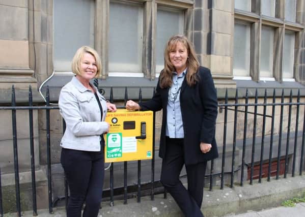 Defibrillator donor Diane Harvey with fundraising champion Lynn Cleal on MacDonald Road. Picture: contributed