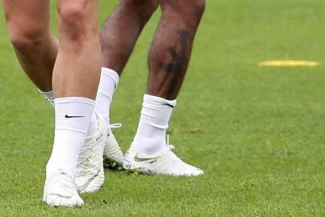 Raheem Sterling visibly showing a tattoo on his leg during a training session at St George's Park, Burton. Picture; Getty