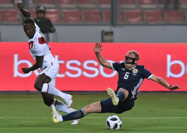 Dylan McGeouch challenges Luis Advincula for the ball. Picture: Cris Bouroncle/AFP/Getty