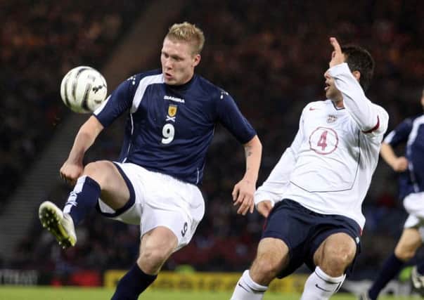 Scotland's Garry O'Connor tangles with USA's Carlos Bocanegra in 2005. Pic: SNS