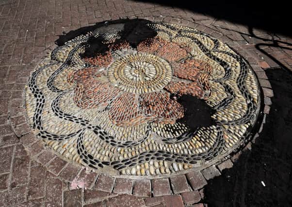 Rose Street's mosaics have been defaced with tar repairs. Picture: Lisa Ferguson