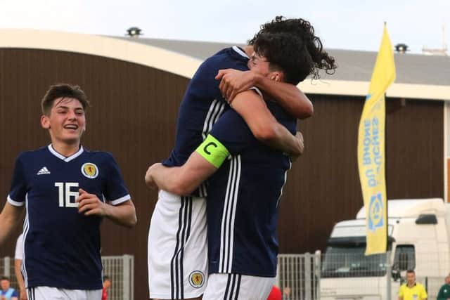 Scotland skipper Oliver Burke is congratulated on his goal. PIc: TGSPhoto/REX/Shutterstock