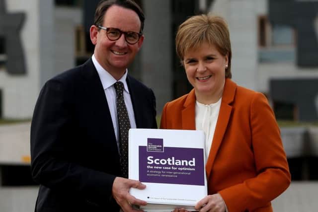 First Minister Nicola Sturgeon receives the Sustainable Growth Commission report from commission chair Andrew Wilson. Picture:: Gordon Terris/The Herald/PA Wire
