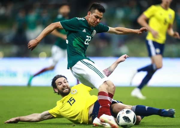 Hirving Lozano of Mexico struggles for the ball with Charles Mulgrew of Scotland during the International Friendly match between Mexico v Scotland at Estadio Azteca. Picture; Getty