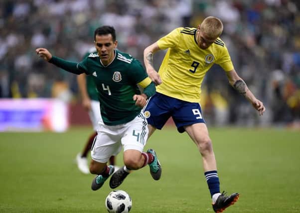 Mexico's Rafael Marquez and Scotland's Oliver McBurnie vie for the ball during their international friendly football match at the Azteca stadium. Picture; Getty