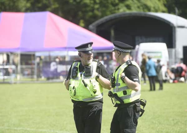 Police officers patrol at the Meadows Festival.