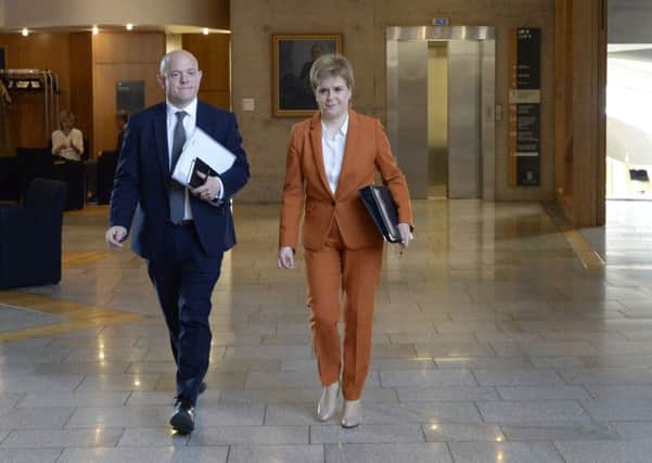 Scotland's First Minister Nicola Sturgeon accompanied by an adviser on the way to First Minister's Questions in the Scottish Parliament on the eve of the SNP Conference. Picture; Getty