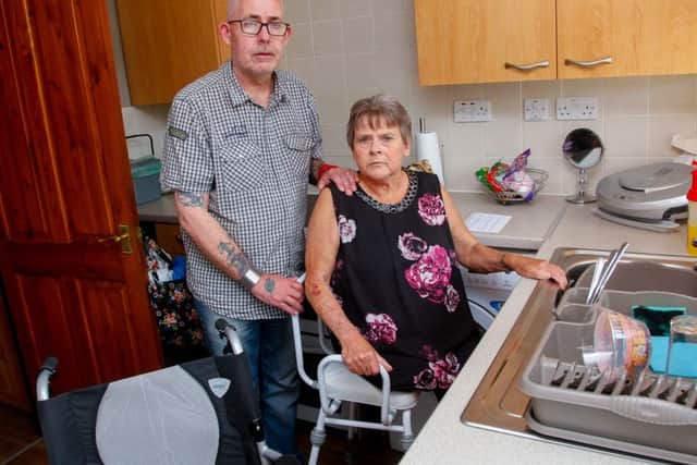 Valerie, pictured with husband Alex,  has to wash in her kitchen sink in a special chair that is higher than her wheelchair to reach the sink. Photo by Scott Louden