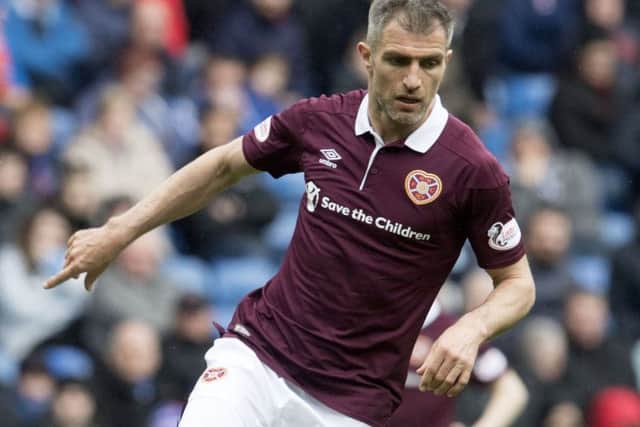 Aaron Hughes will be play for one more season