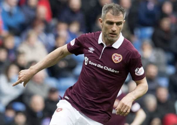 Aaron Hughes will be play for one more season