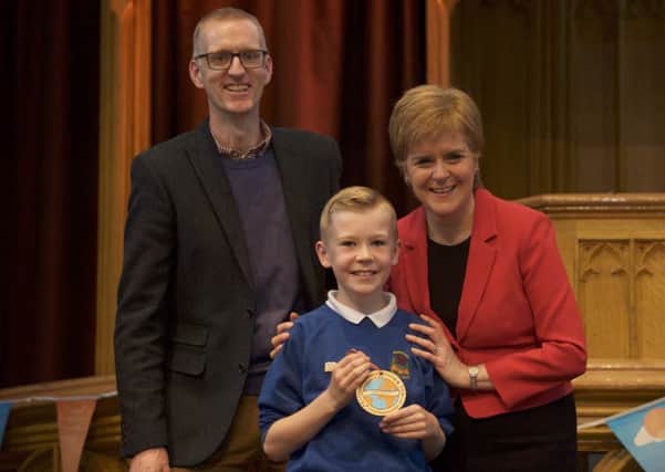 Rosewell Primary pupil Noah Haycox, winner of the First Ministers Reading Challenge: Pupil Reading Journey P5: pictured with his father Michael Haycox, and First Minister Nicola Sturgeon.